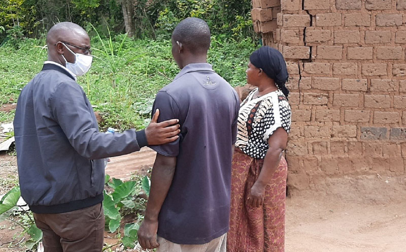 Mutyaba with his mother and a YouBelong worker