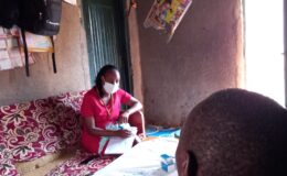 A YBH Social worker listens to a family member and the service user during a post dischahrge visit
