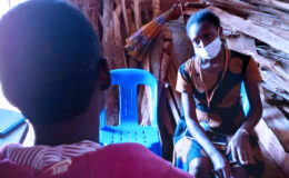 A YouBelong Social Worker listens as 'Jane' speaks during a family visit