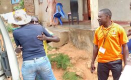 A family member embraces 'Ivan' after return home from the hospital as the YBU team member looks on