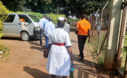 Discharged persons being escorted to YBU Van by the YBU team and Hospital Health worker after discharge